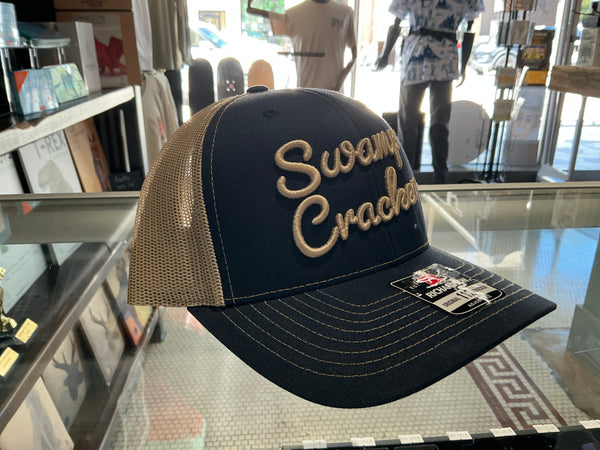 Swamp Cracker mesh blue and tan hat, cursive writing